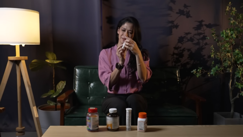 A Woman Holding a Bottle of Vitamin C Supplements