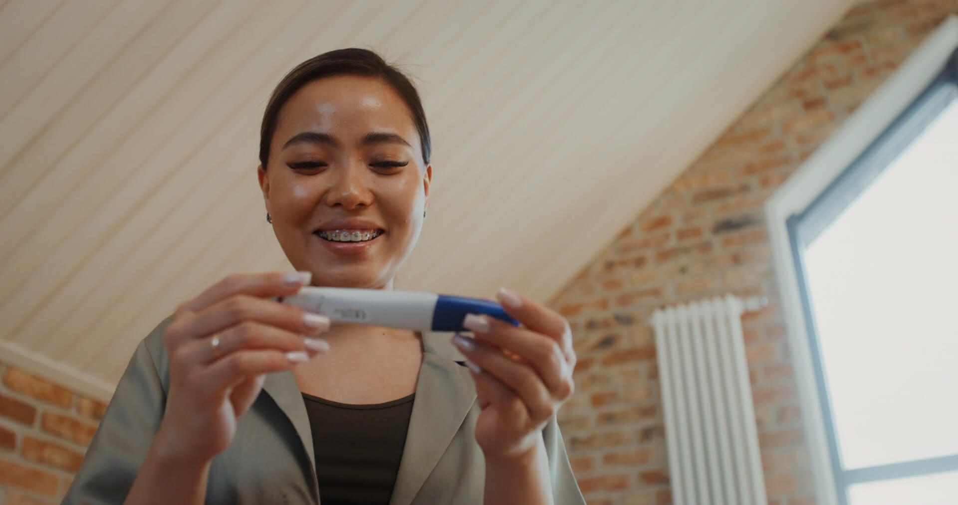 A girl is looking at a pregnancy test