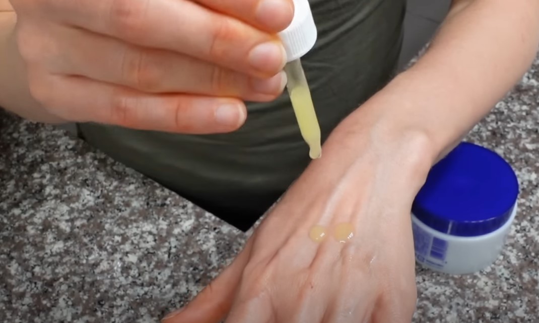 Woman pouring ubiquinol on her hand